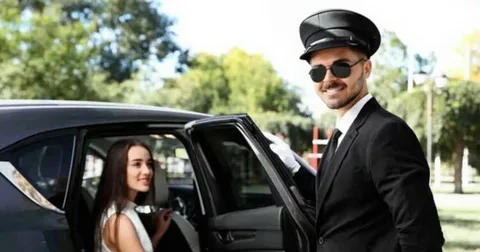 A well-dressed man in a suit and hat exits a car, highlighting the luxury of private car drivers in Dubai