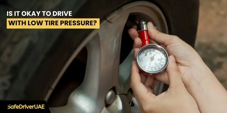 A close-up of a car tire on a road, emphasizing the risks of driving with low tire pressure