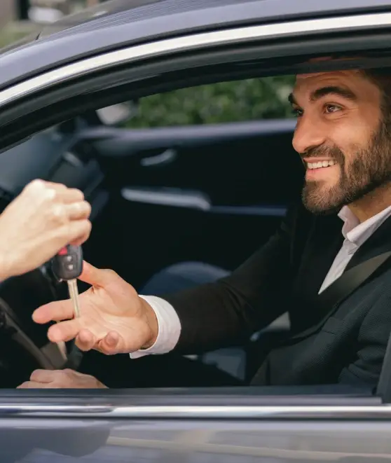 Professional safe driver in Dubai handing car keys to happy customer in luxury car, 8+ years experience, 1700+ rides